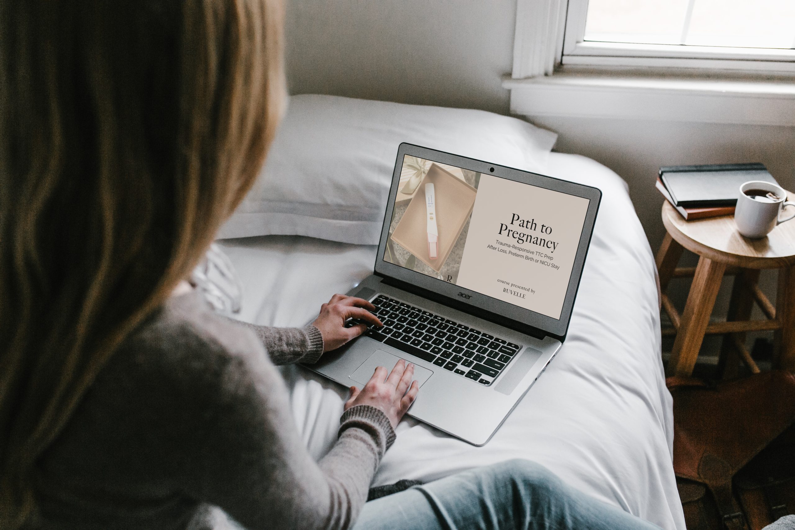woman sitting on touch looking at laptop with Parijat's face on the screen